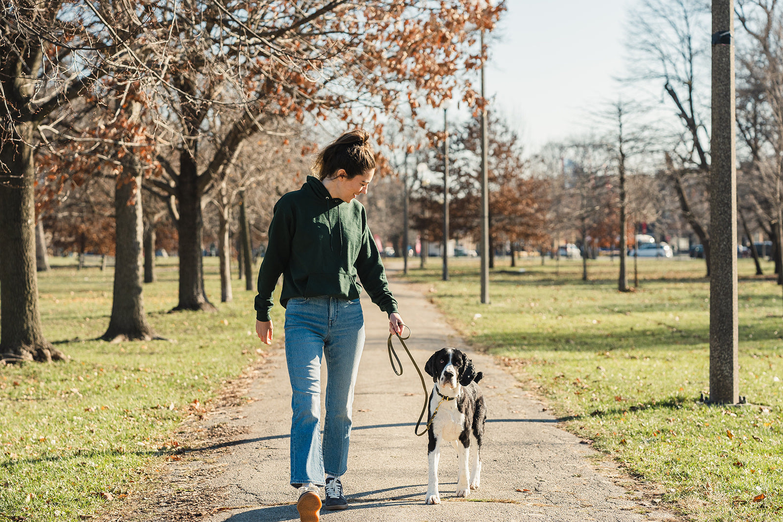 Maddie and Rudder walking together through the park